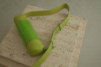 Kaboompics - Neon Green Crossbody Bag on a Textured Stone Bench