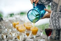Kaboompics - Orange Juice Pouring among Wine and Water Glasses