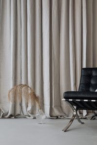Kaboompics - Dried Palm in Glass Vase Beside Black Chair and Linen Curtains