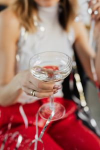 Kaboompics - Seated Champagne Toast with Silver Streamers on Red Suit