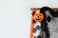 Kaboompics - Halloween Pumpkin Bucket with Spiderwebs and Black Wall Decoration