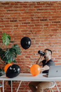 Kaboompics - Photographer Taking a Picture with MacBook and Halloween Balloons
