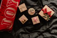 Kaboompics - Christmas Present with Red Ribbon on Black Bedding