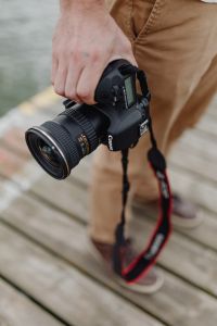 Kaboompics - Photographer holding a DSLR camera