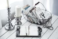 Kaboompics - Overhead View of an Open Organizer and Silver Candlesticks