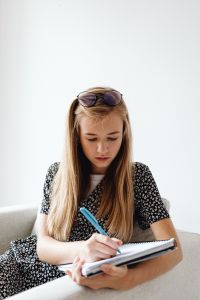 Kaboompics - Girl Doing Homework in Notebook