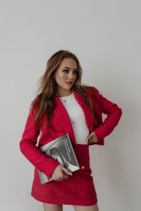 Kaboompics - Woman in Pink Suit Reading a Fashion Magazine