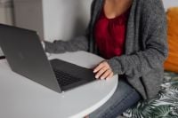 Kaboompics - A brunette woman works with a laptop and a phone