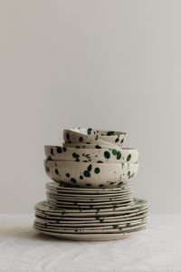 Kaboompics - Layered Green Splatter Bowls and Plates with Generous Background Space
