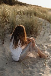 Kaboompics - Faceless Woman Resting in Sand Dunes