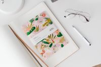 Kaboompics - Close-Up of Illustrated Planner, Pencil Cup and Eyeglasses