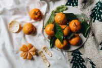 Kaboompics - Mandarins with Green Leaves and Dried Citrus on Linen