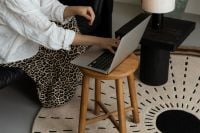 Kaboompics - Woman Working on Laptop From Sofa in Stylish Living Room