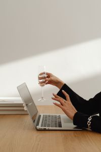 Kaboompics - Businesswoman Working on a Laptop with a Glass of Wine