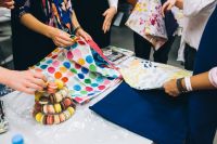 Kaboompics - People examining fabrics by a meringue tower