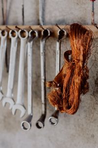 Kaboompics - Copper Wire Coil in Front of a Hanging Wrench Rack