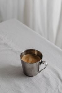 Kaboompics - Chrome Coffee Cup on White Tablecloth