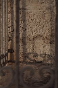 Kaboompics - Rough Stone Wall and Metal Gate Architectural Texture
