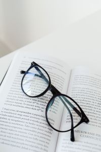 Kaboompics - Eyeglasses Resting on Open Book Pages for a Reading Scene