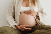 Kaboompics - Pregnant Woman Sitting and Holding Her Belly