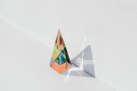 Kaboompics - Colorful Glass Prism Casting a Long Diagonal Shadow on a White Surface