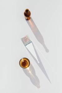 Kaboompics - Amber Glass Bud Vases and a Clear Sculptural Glass Object in Sunlight