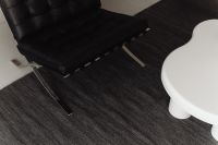 Kaboompics - Black Leather Chair Beside a White Coffee Table