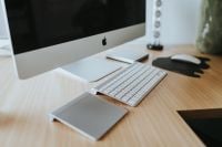 Kaboompics - Apple iMac Home Office Desk with White Keyboard, Mouse and Elephant-Shaped Mouse Pad