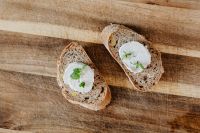 Kaboompics - Goat Cheese Crostini With Mint on a Wooden Cutting Board