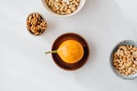 Kaboompics - Overhead Mixed Nuts and Passion Fruit on Marble for Tropical Recipe Layouts