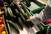 Kaboompics - Woman Selecting Zucchini at a Farmers Market