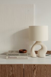 Kaboompics - Cream Ceramic Lamp and Wood Bowl Styled on a Stack of Books