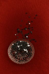 Kaboompics - Glass Dish with Star Confetti on Burgundy Background