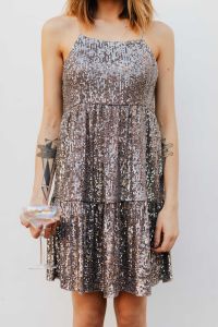 Kaboompics - Cropped Woman in Silver Sequin Dress Holding Champagne