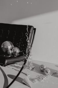 Kaboompics - Shadowy Black Chair with Disco Balls and Curled Silver Ribbon