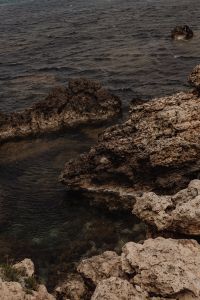 Kaboompics - Rough Blue Sea Beside a Dark Rocky Shore