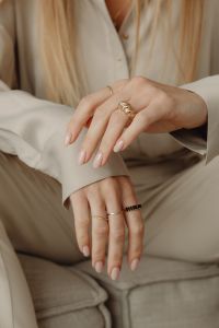 Kaboompics - Woman Sitting in Tan Silk Shirt Wearing Gold Rings