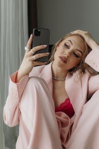 Kaboompics - Hands Adjusting a Pale Pink Blazer with Rings