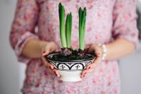 Kaboompics - Woman in pink holding a plant