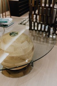 Kaboompics - Wooden Sphere Coffee Table with Glass Top and Interior Books