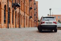 Kaboompics - White Car Parked beside the Historic Brick Factory at Manufaktura, Łódź
