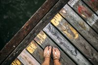 Kaboompics - Detail of the legs of a woman standing at the edge of the pier