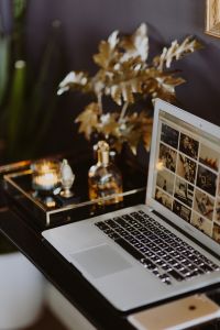 Kaboompics - Soft Focus Home Office with Laptop, Gold Foliage and Candle