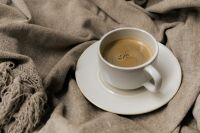 Kaboompics - White Coffee Cup on Gray Throw Blanket