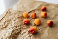 Kaboompics - Orange Apricot Close-Up on Crumpled Paper, Natural Fruit Texture for Recipe and Packaging Design