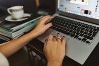 Kaboompics - Woman Using Laptop With Coffee At Home Office
