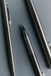 Kaboompics - Close-Up of Silver Fountain Pens on Blue Background