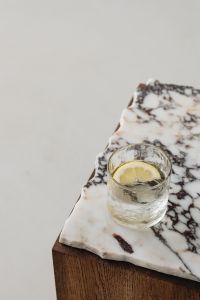 Kaboompics - Lemon Water on a Marble-Topped Wooden Table With Copy Space