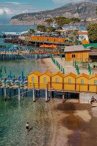 Kaboompics - Sorrento Beach Cabins And Swimmer In Clear Mediterranean Water