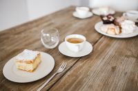 Kaboompics - Sweet dessert with cream an a cup of coffee on a table